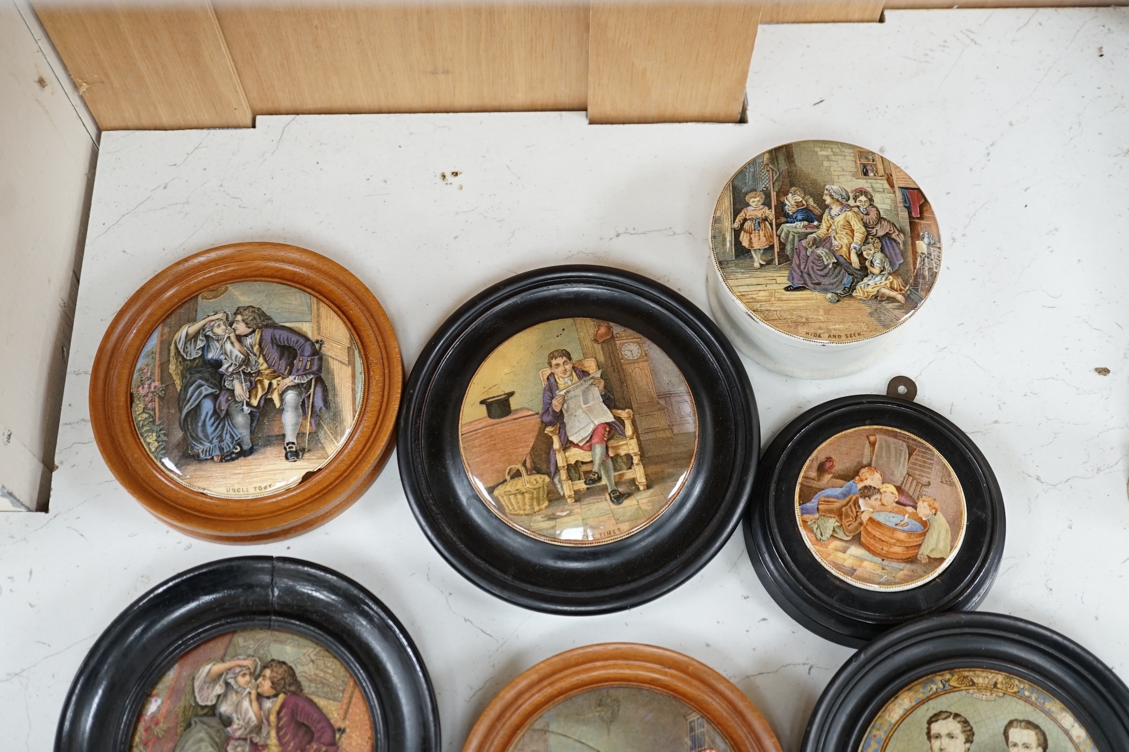 Nine 19th century framed pot lids including ‘Hide and Seek’ and ‘Uncle Toby’ and a jar and cover, largest overall 16cm diameter. Condition - fair to good